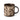A stoneware mug in a dark brown colour, decorated with a cream wax resist leaf pattern, photographed on a clean white background.