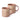Two stoneware mugs in a dusty blush pink colour, decorated with a cream wax resist leaf pattern, photographed on a clean white background.