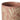 A closeup of the top edge of a stoneware mug in a dusty blush pink colour, decorated with a cream wax resist leaf pattern, photographed on a clean white background.