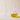 Two clear glass oil & vinegar pourers with curved spouts, the conical bottle is empty and the rounded bulb-shaped bottle is filled with olive oil, shown on a beige background.