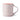 A classic ceramic mug with a light pink exterior and a bright red interior with a curved handle. Photographed on a clean white background.